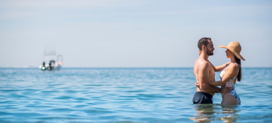 married-couple-on-the-turquoise-blue-beach-of-club-regina-puerto-vallarta